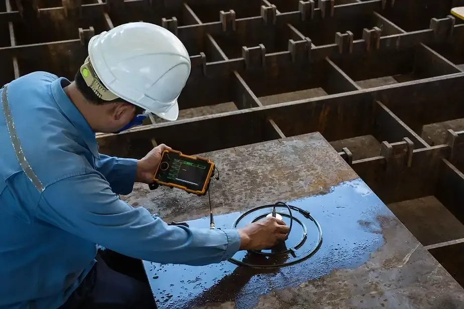 Engineer reviewing accredited test results on a digital report